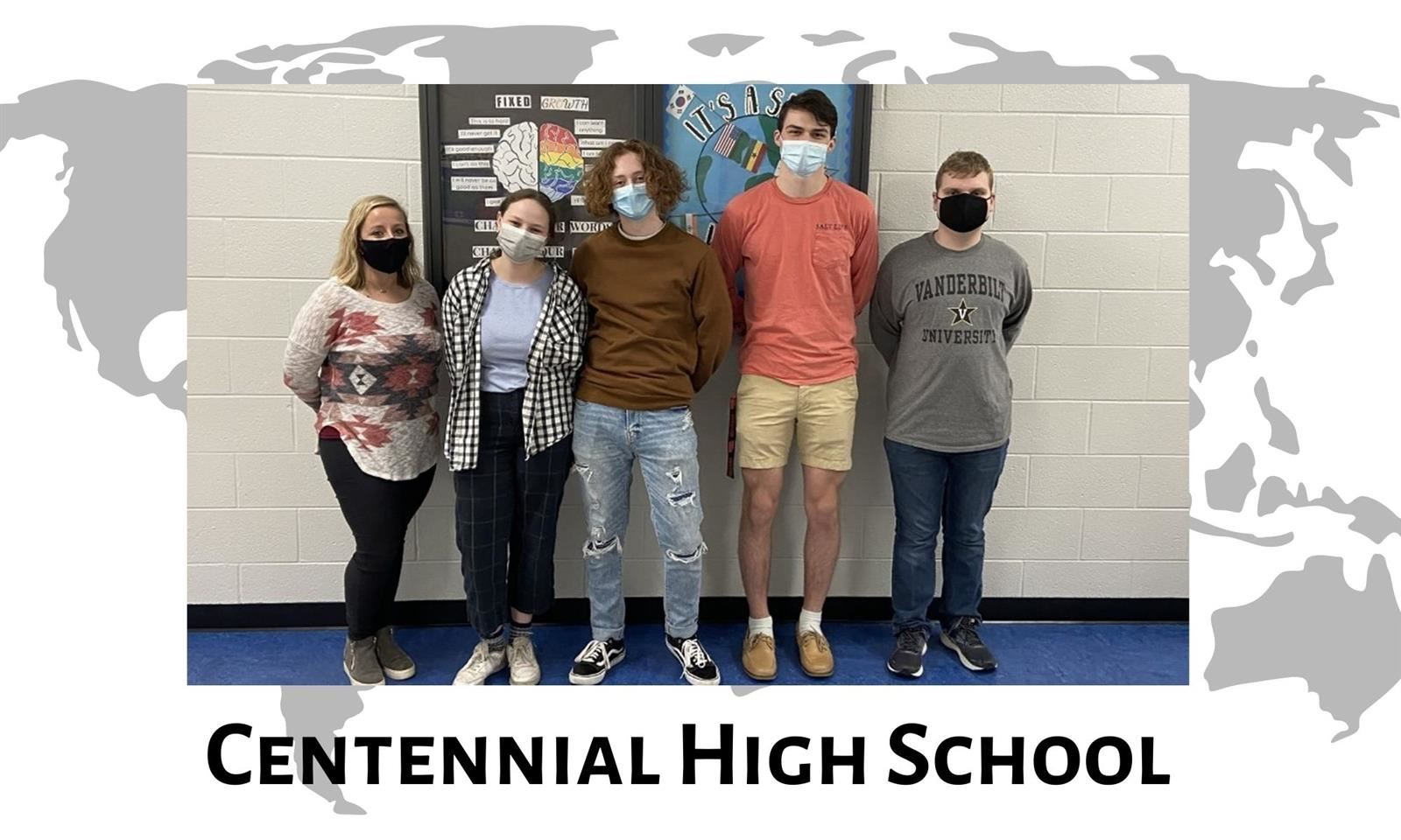 Four students and a teacher stand against a w all 